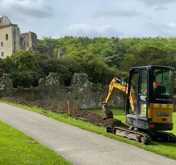 Old Wardour Castle in the background with digger to the right